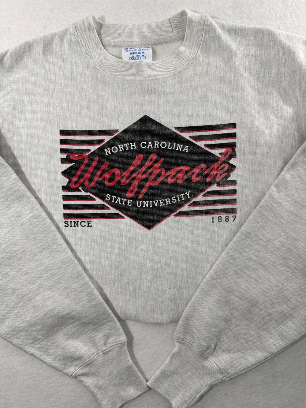 Champion Gray Crewneck Sweatshirt with Black and Red Wolfpack Logo